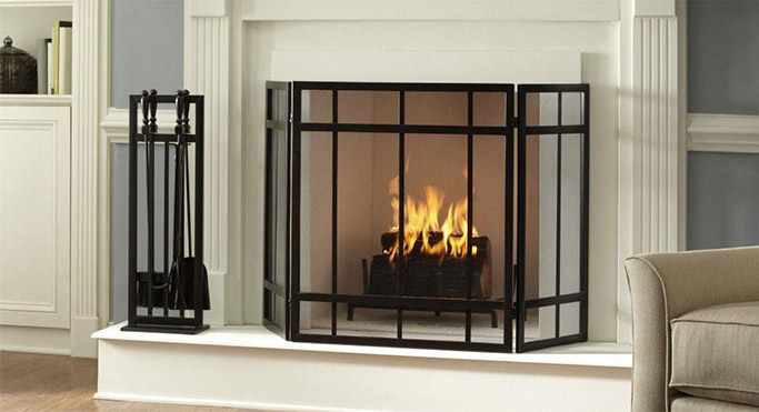 Once framing and venting for the appliance has been completed, the fireplace can be finished with a noncombustible veneer and mantel of your choosing. In this example, a wooden mantel has been used to flank a raised marble hearth and inner surround.